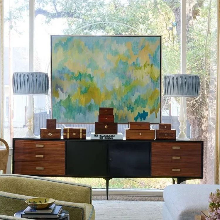 "Capriccio Si" painting by Robert Rea hanging in front of window