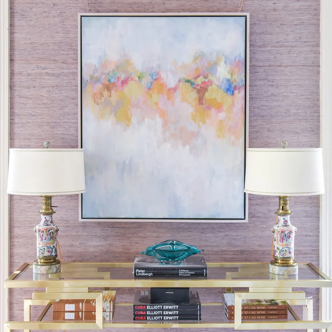 Pastel painting hung between lamps