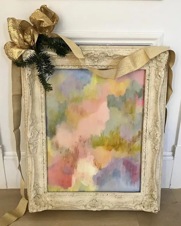 Painting with elaborate frame with a bow for gifting